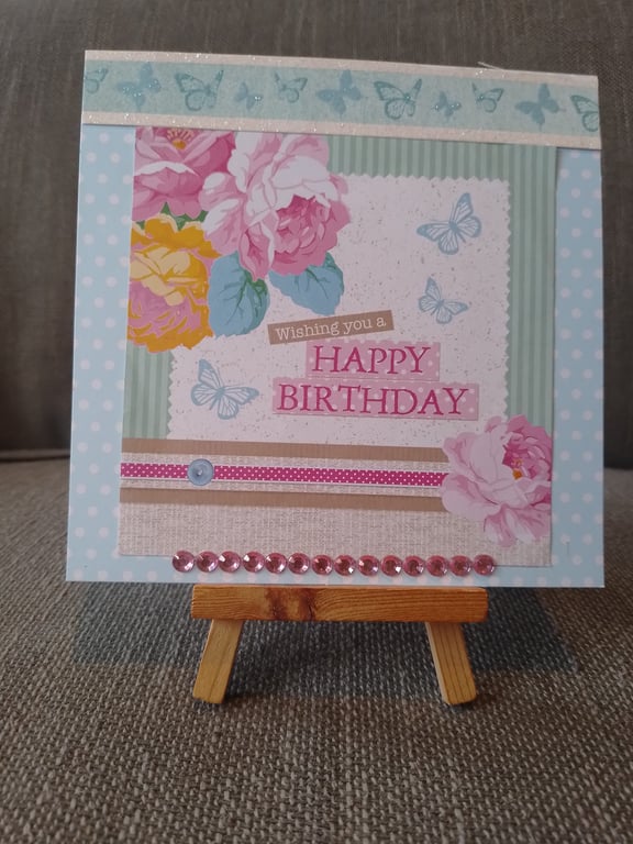 a happy birthday card with flowers and butterflys