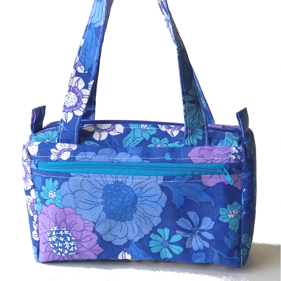 Small, boxy handbag in blue retro floral print