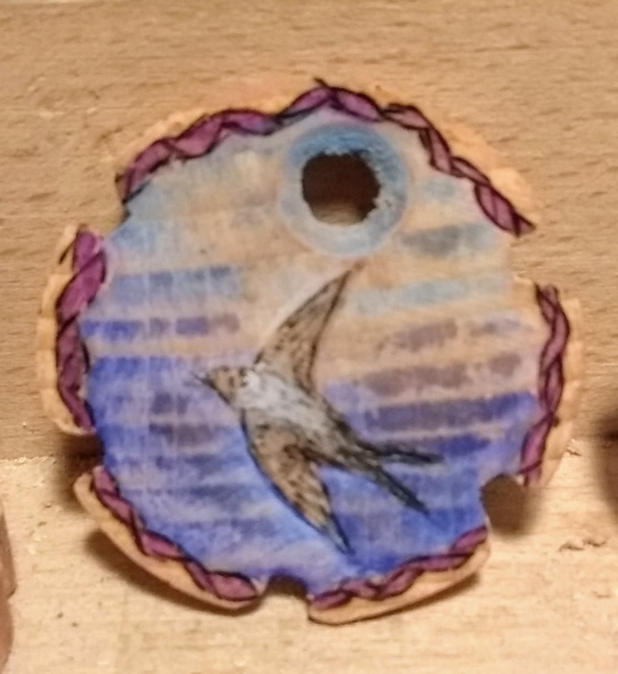 House martin pendant with  coloured ornamental turning on the rear
