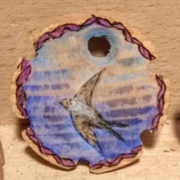 House martin pendant with  coloured ornamental turning on the rear