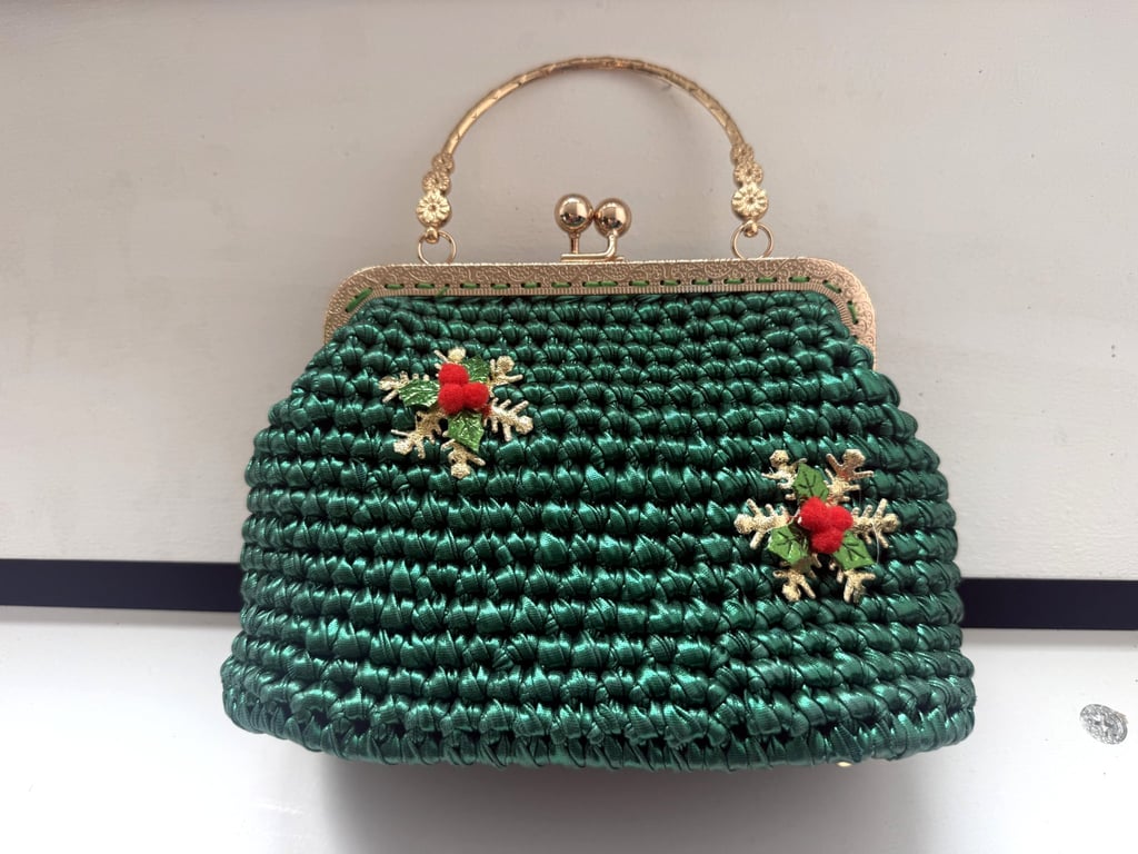 Green crocheted handbag with Christmas snowflake decoration