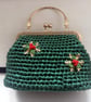 Green crocheted handbag with Christmas snowflake decoration