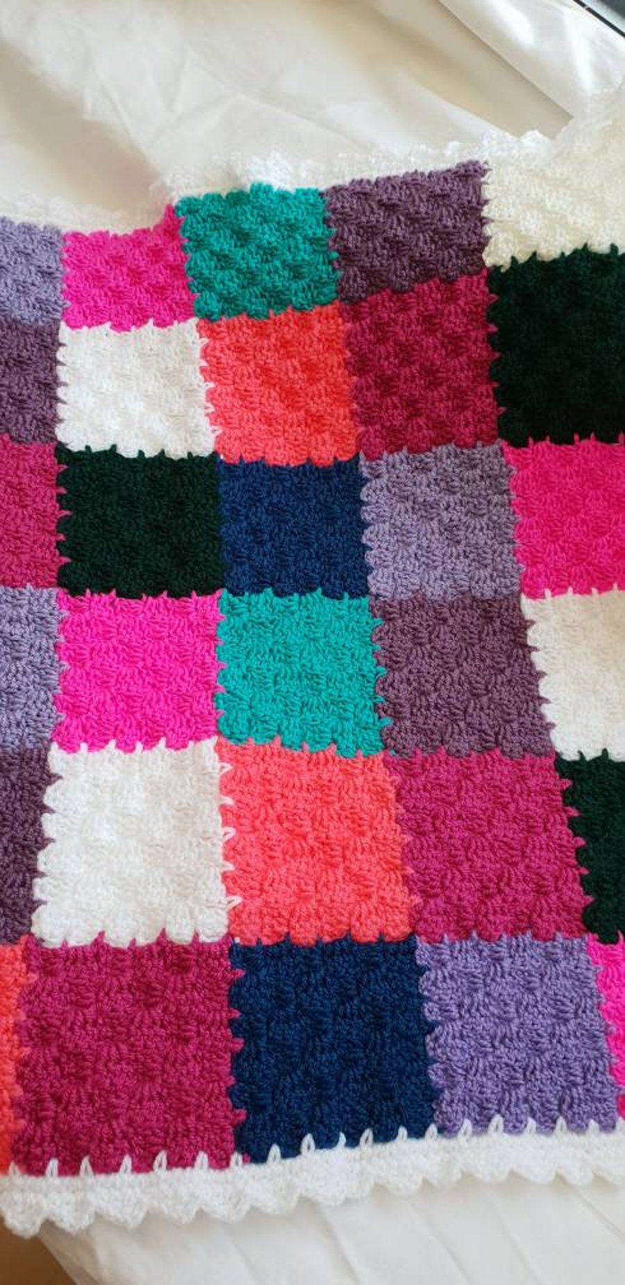 Handmade multi coloured patchwork crocheted baby blanket