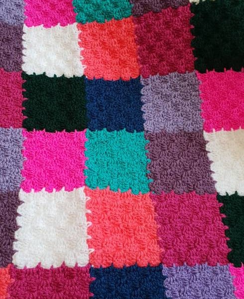 Handmade multi coloured patchwork crocheted baby blanket