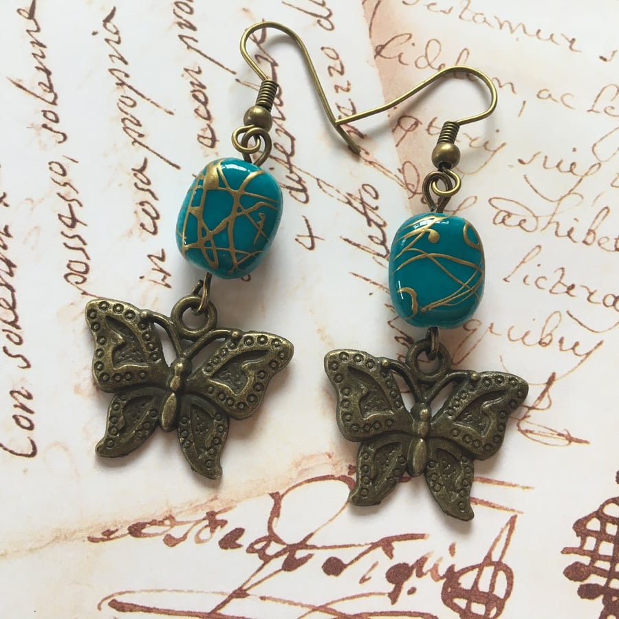  Butterfly charm on turquoise beads dangle earrings.
