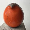 Orange carved round bird