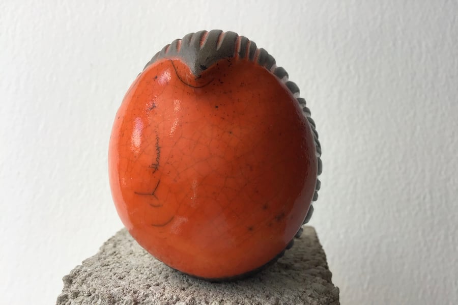 Orange carved round bird