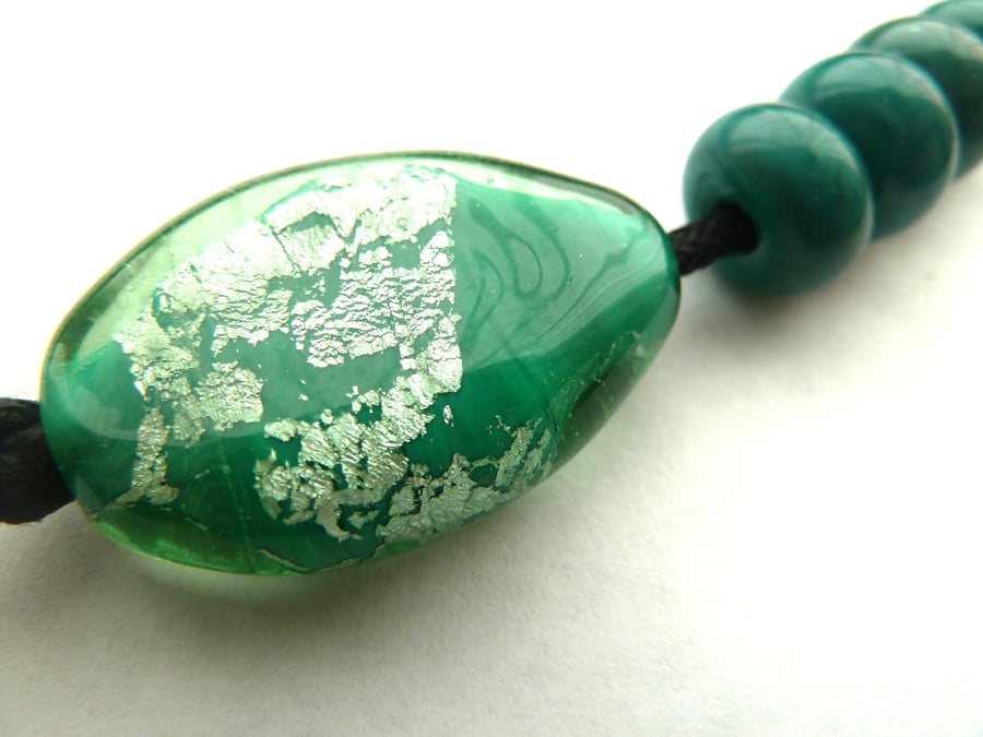 green and silver focal lampwork bead