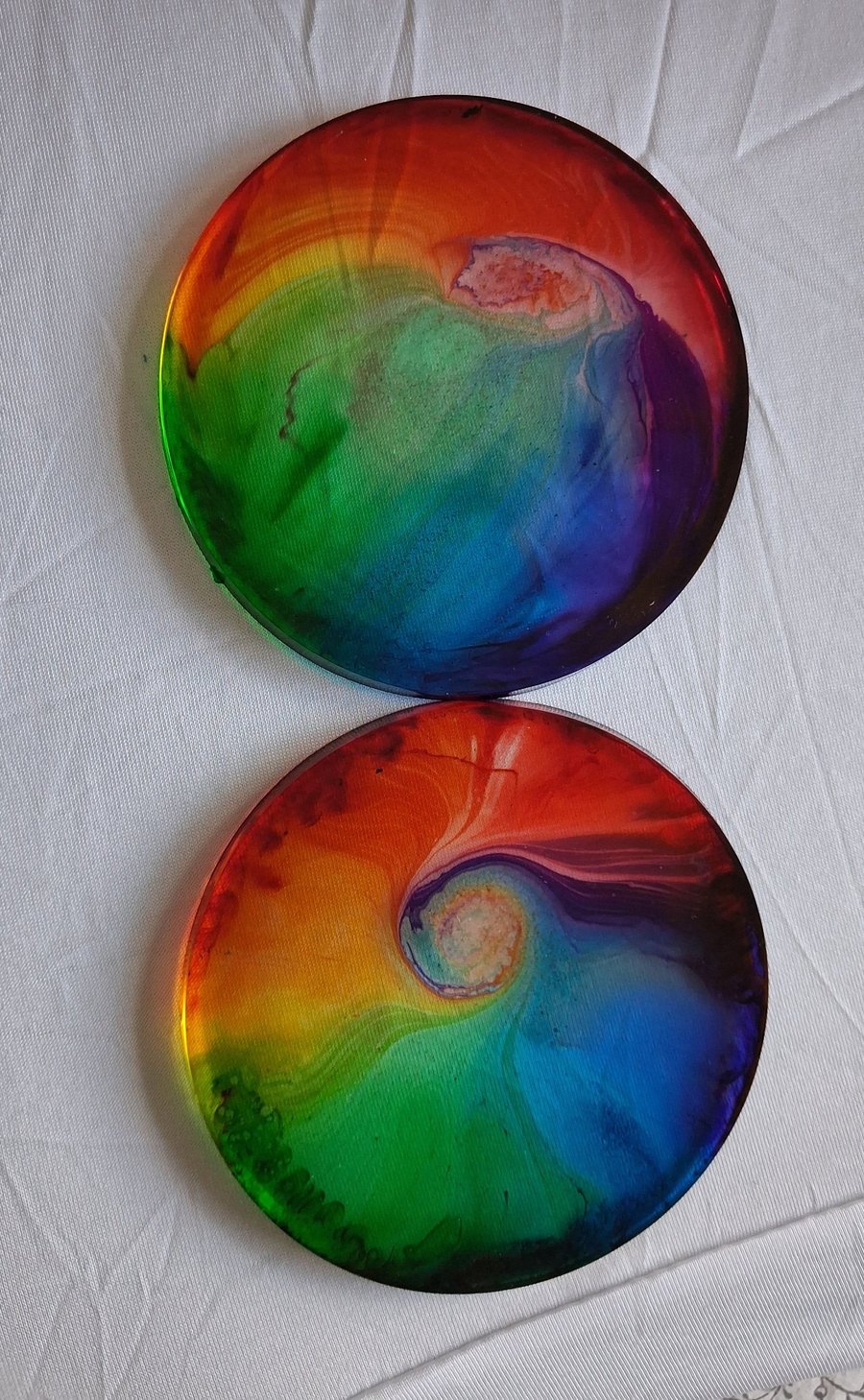 Set of two handmade epoxy resin round coasters. Rainbow swirl