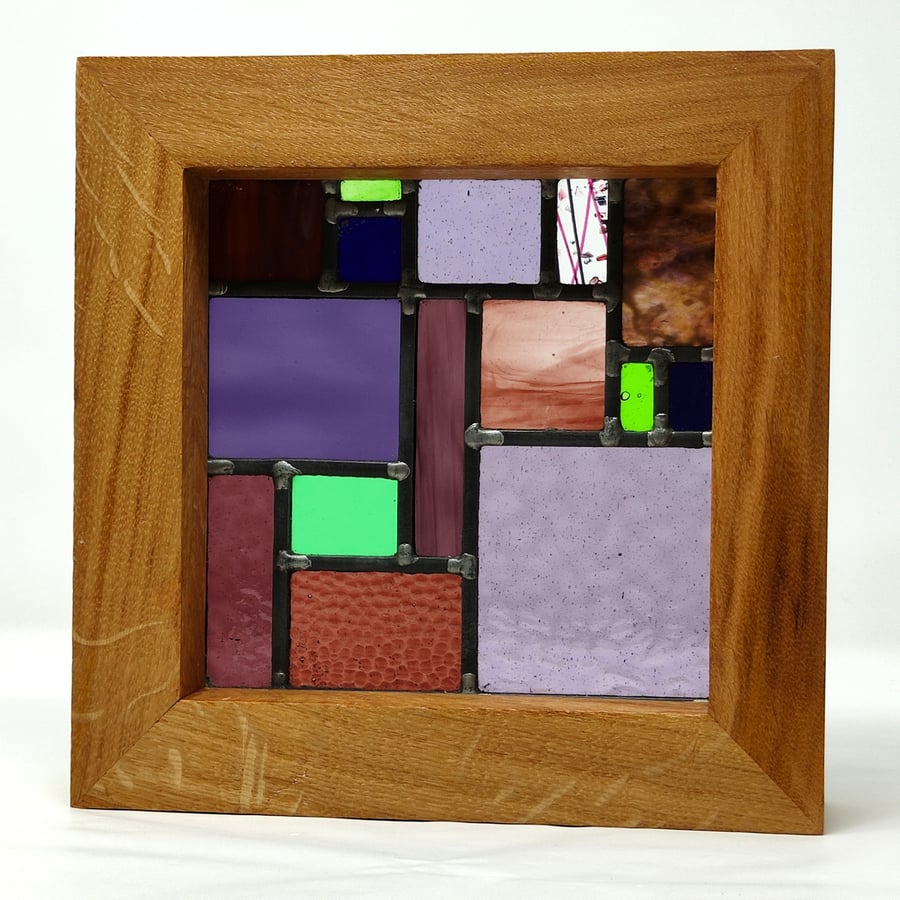 Stained glass geometric framed leaded panel - purple, violet and green. 