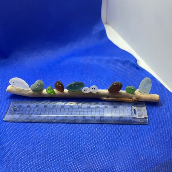 Frosted sea glass 'nuggets' on driftwood.