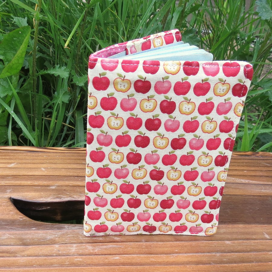 Apples.  A fabric passport cover.