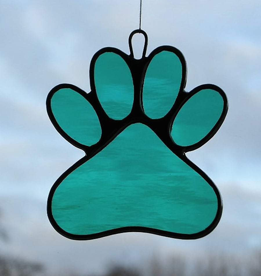 Paw Print suncatcher in teal green rippling water glass