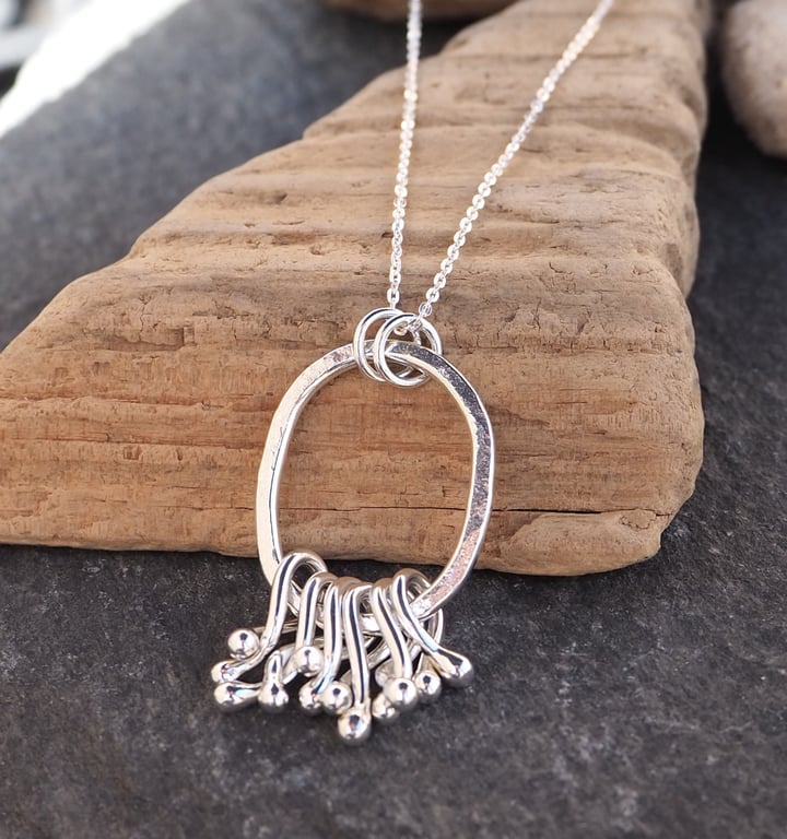 Sterling silver 'hug' pendant necklace, hammered silver, silver twists pendant