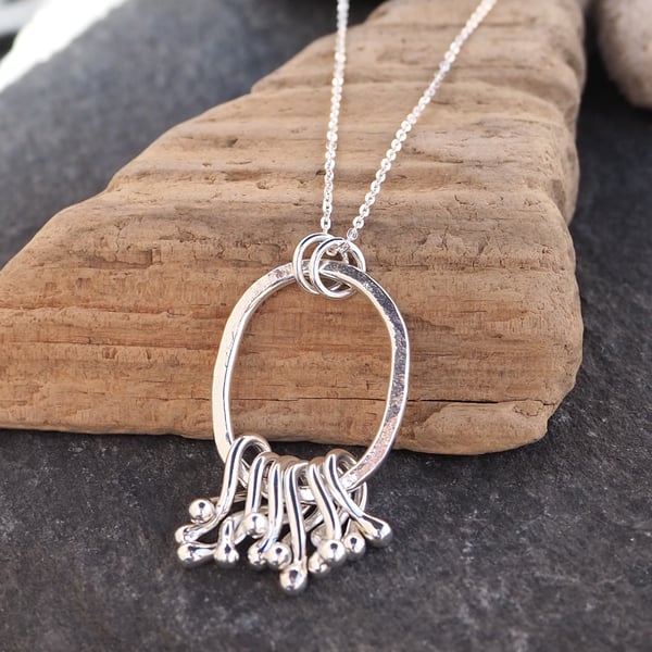 Sterling silver 'hug' pendant necklace, hammered silver, silver twists pendant