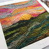 Embroidered wet felting landscape of the sun setting. 