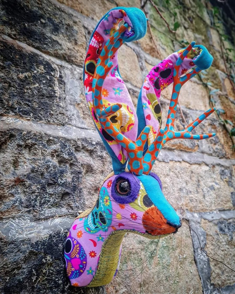 Faux jackalope head wall mount in Day of the Dead skull style fabric