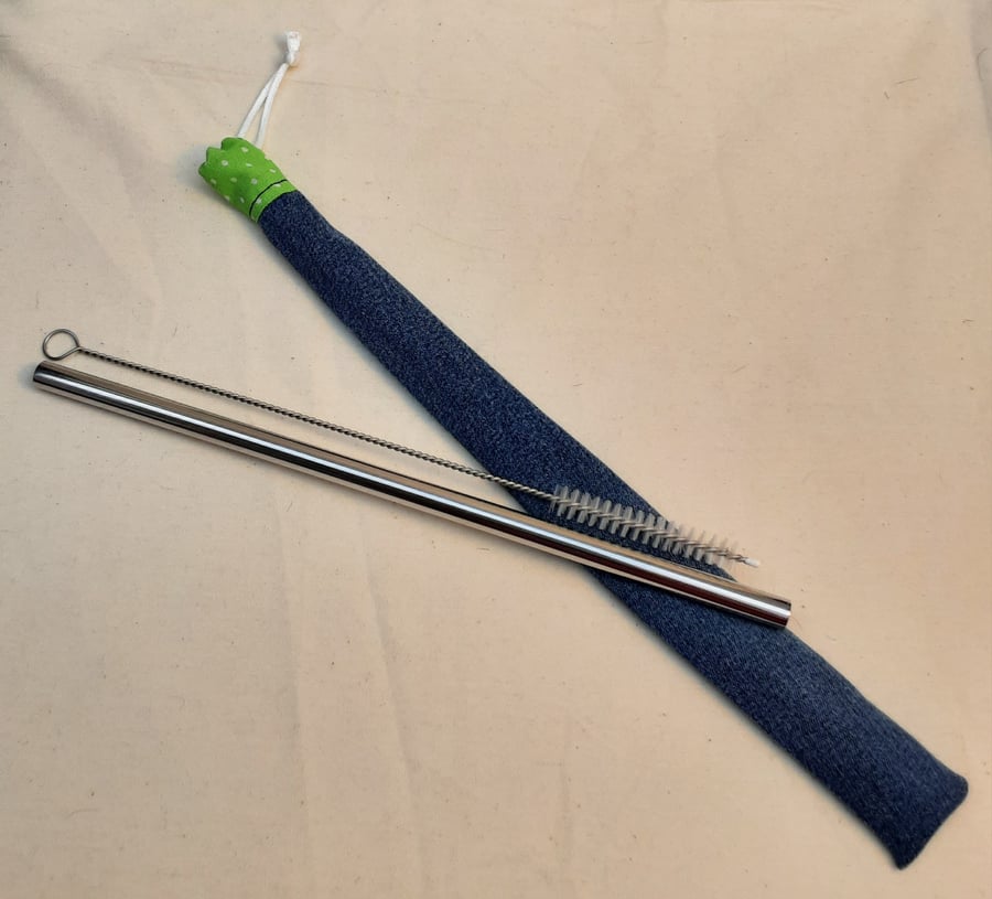 Reusable metal straw and cleaning brush with denim cover.