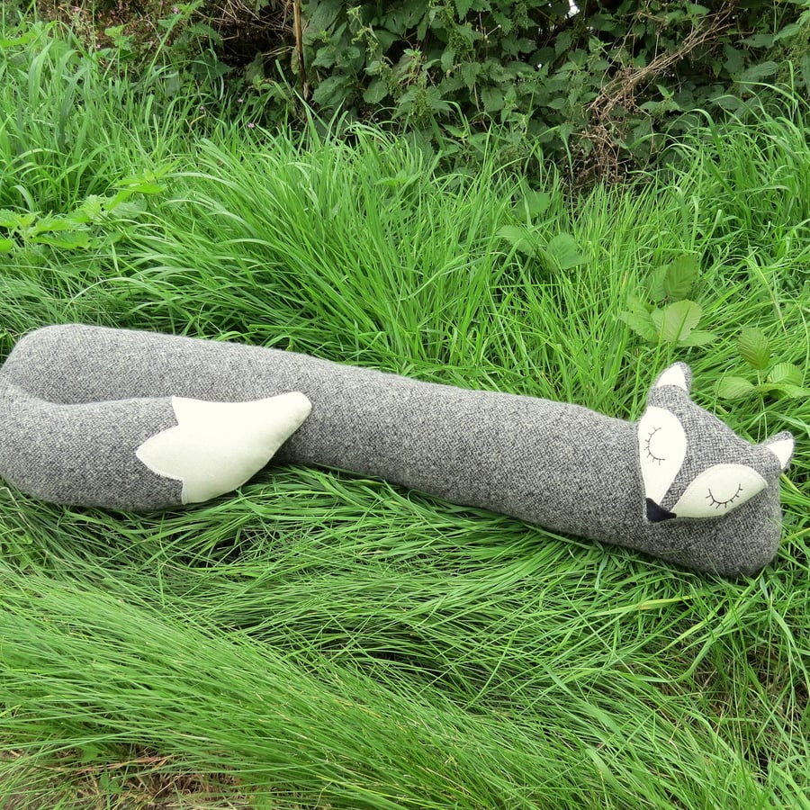 Long fox.  A draught excluder made from a textured boucle wool.  Draft excluder.