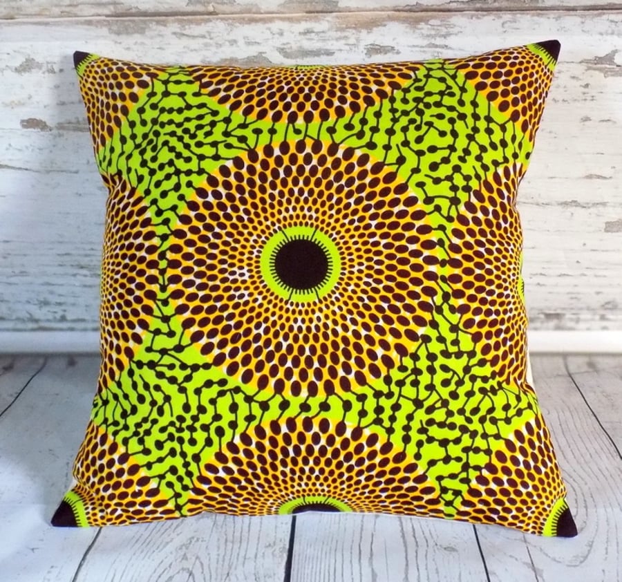 Cushion cover. African wax print, orange and brown circles on lime green