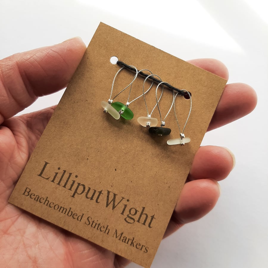 Five clear, brown and green sea glass stitch markers