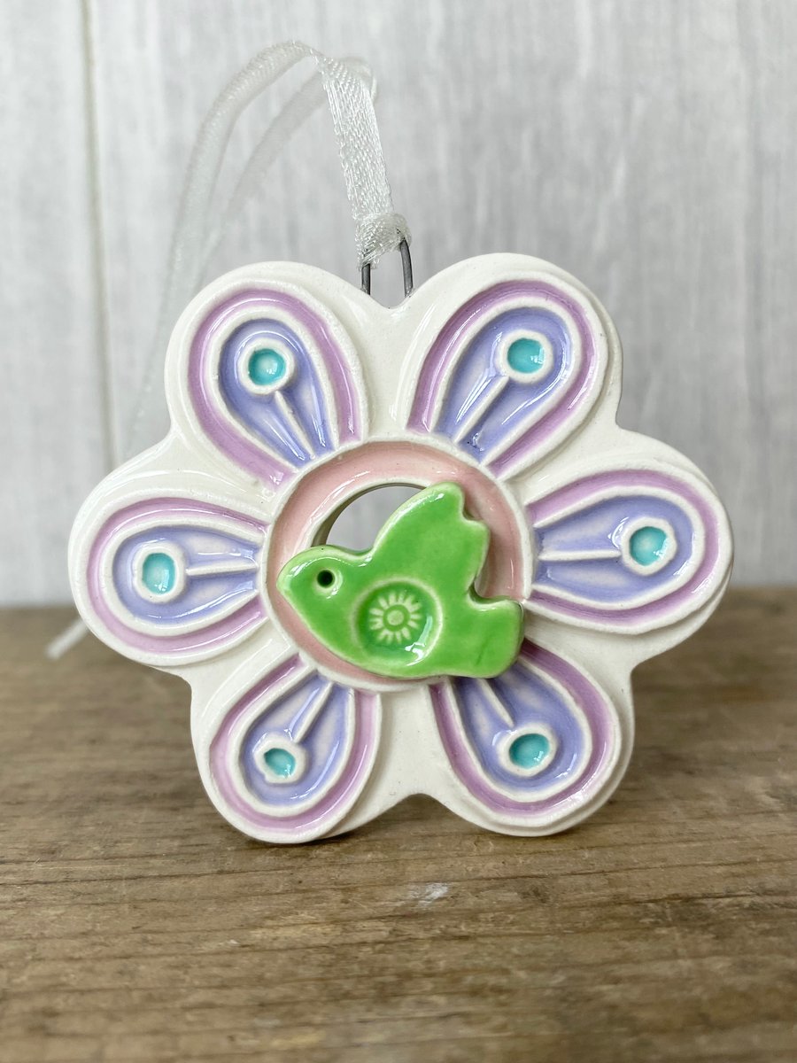 Intricate ceramic flower decoration with bird lilac