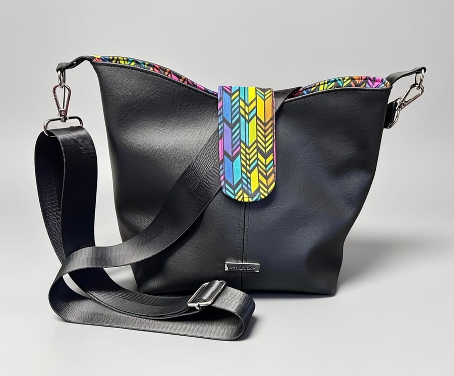 Classic black bucket bag with vibrant inside
