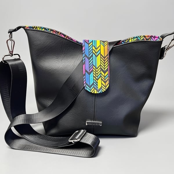 Classic black bucket bag with vibrant inside