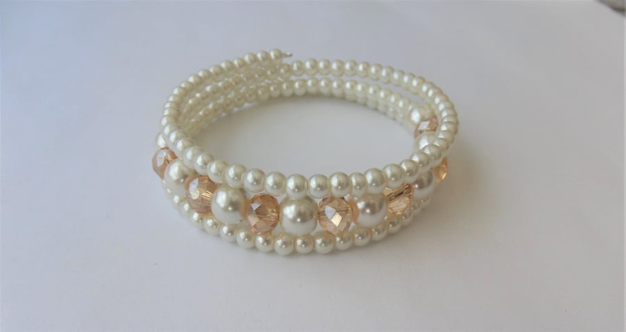Champagne crystal rondelle and cream glass pearl memory wire bracelet.