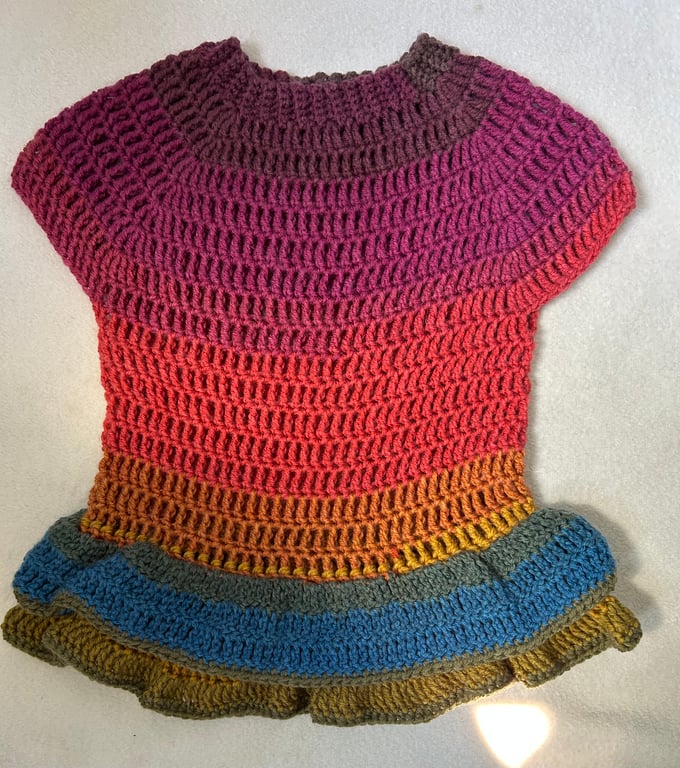 Multicoloured dress with double frill, crocheted by hand.
