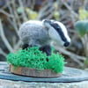 Needle felt Badger mounted on a wood slice 