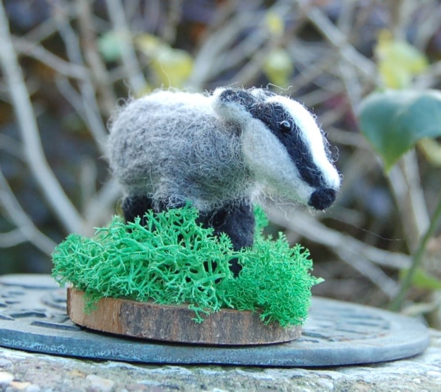 Needle felt Badger mounted on a wood slice 