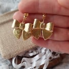 Gold bow dangle earrings.