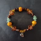 Elasticated Autumnal beaded bracelet with silver pumpkin charm 