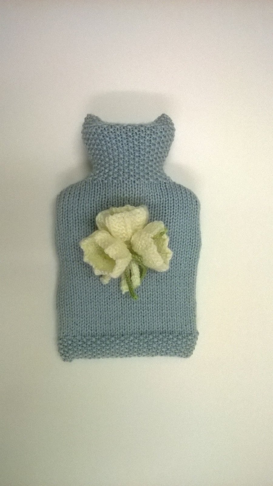 Hand knitted Blue Hot Water Bottle with  white crocus  