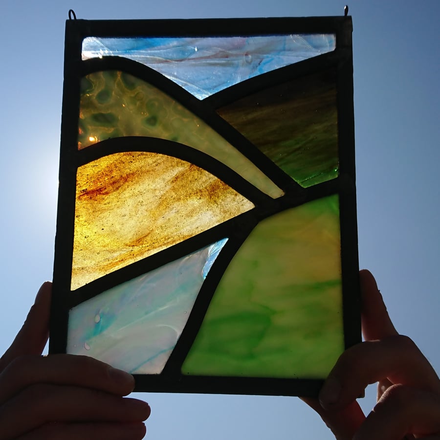 Stained glass green mountains brown hills leaded panel