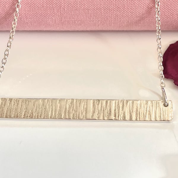 Solid hammered bar pendant 