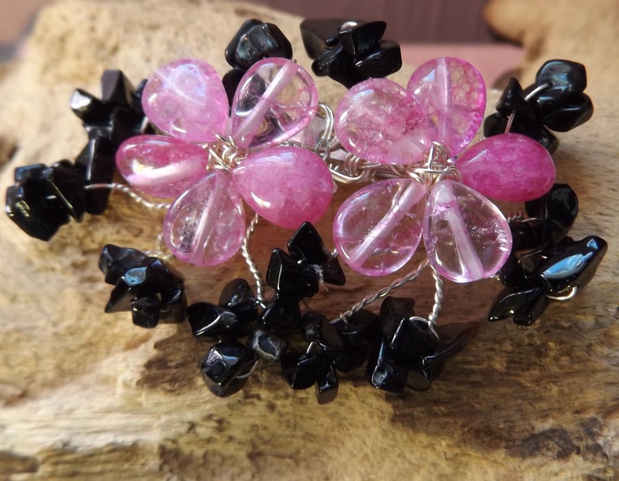 Pink quartzite flower brooch with black onyx