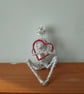 Figure sculptured out of wire Holding onto love