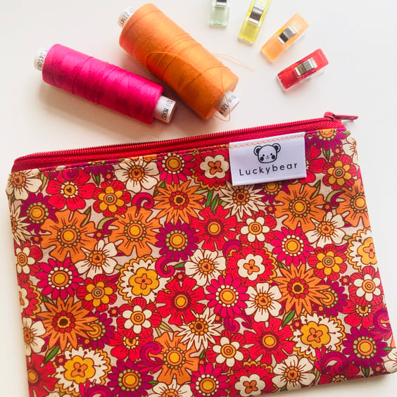 Bold vintage style floral print zip pouch in oranges, reds & pinks (small)