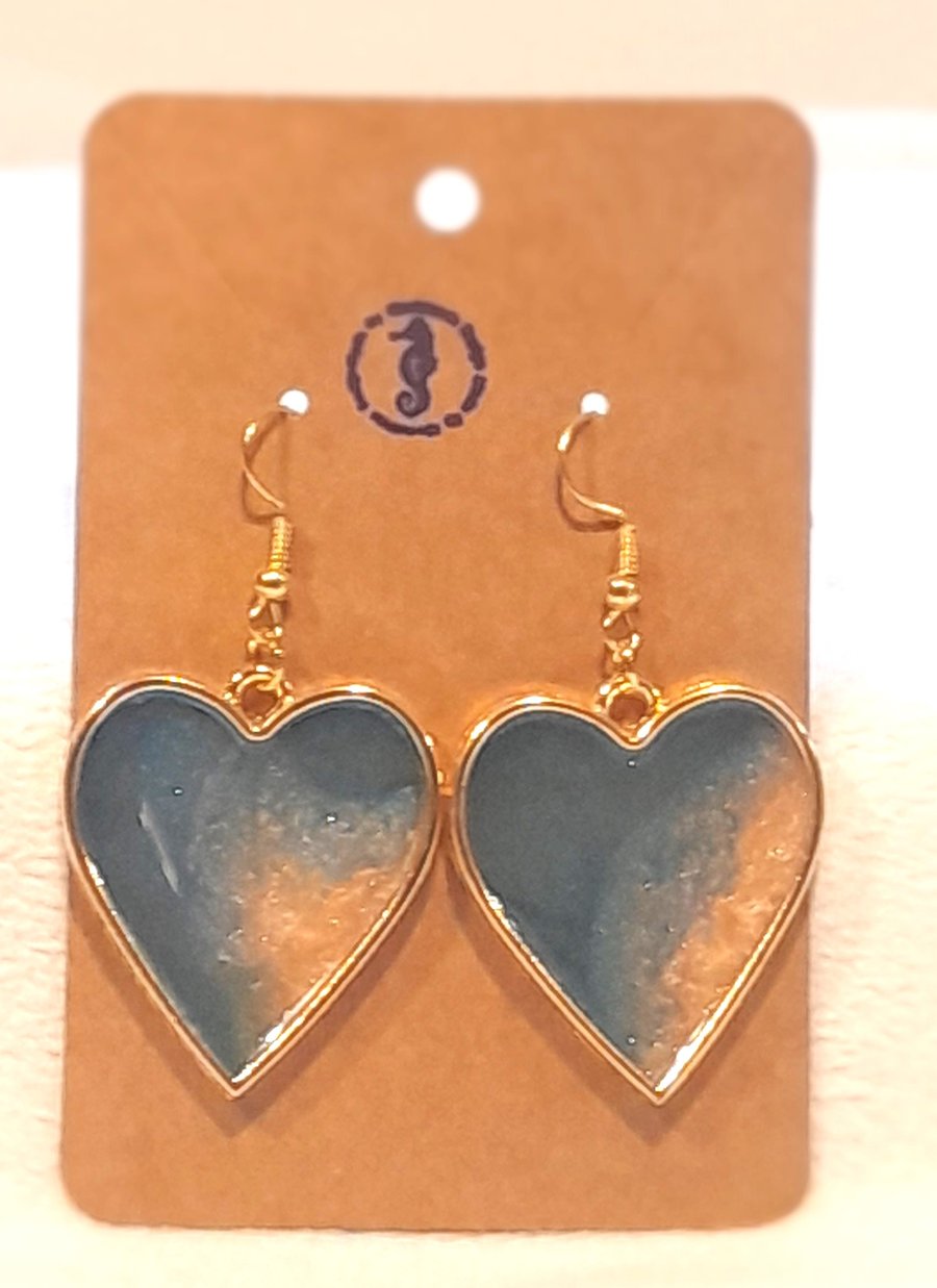 Heart shaped resin earrings filled with blue and gold resin