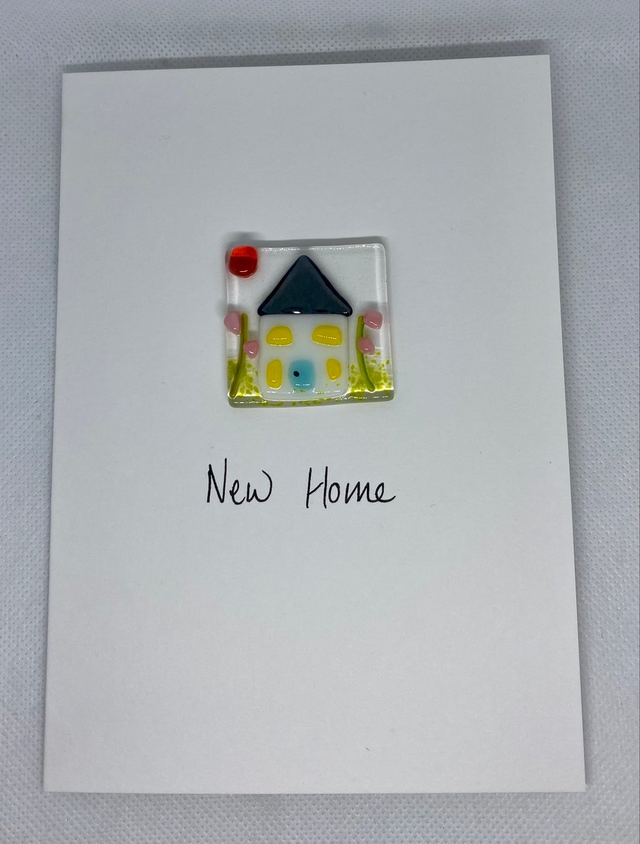 New home card with a fused glass panel featuring a little house and garden  