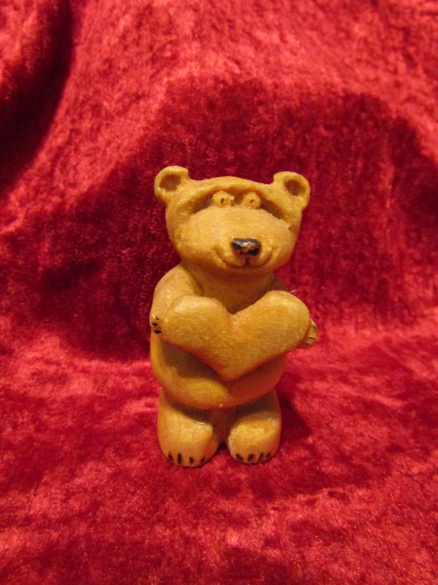 Cute wooden bear holding a love heart