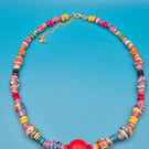 Colourful and vibrant paper beaded necklace made with circus flyers