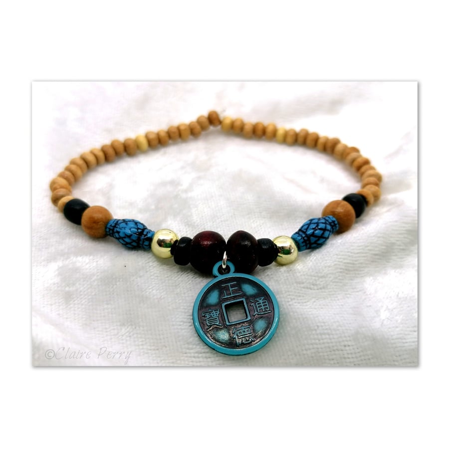 Wooden Surfer's bead bracelet with Turquoise luck coin charm bead.