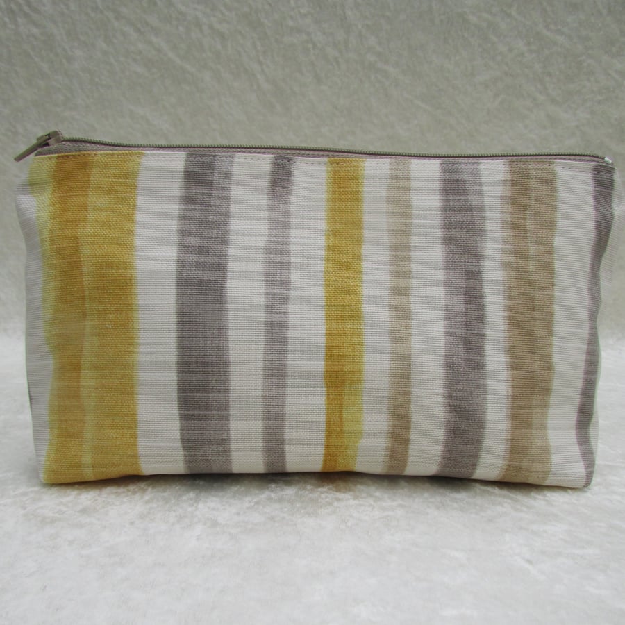 Striped cosmetic bag in golden yellow, grey, white and beige