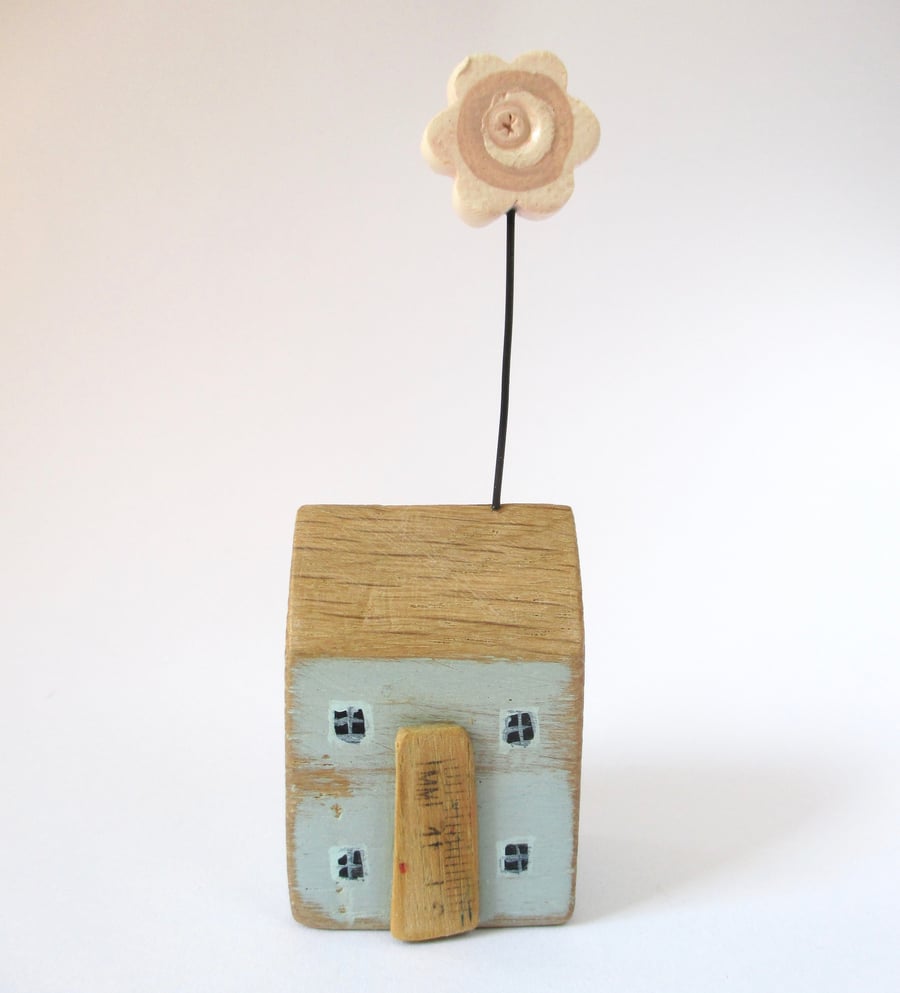 Little wooden house with pink flower