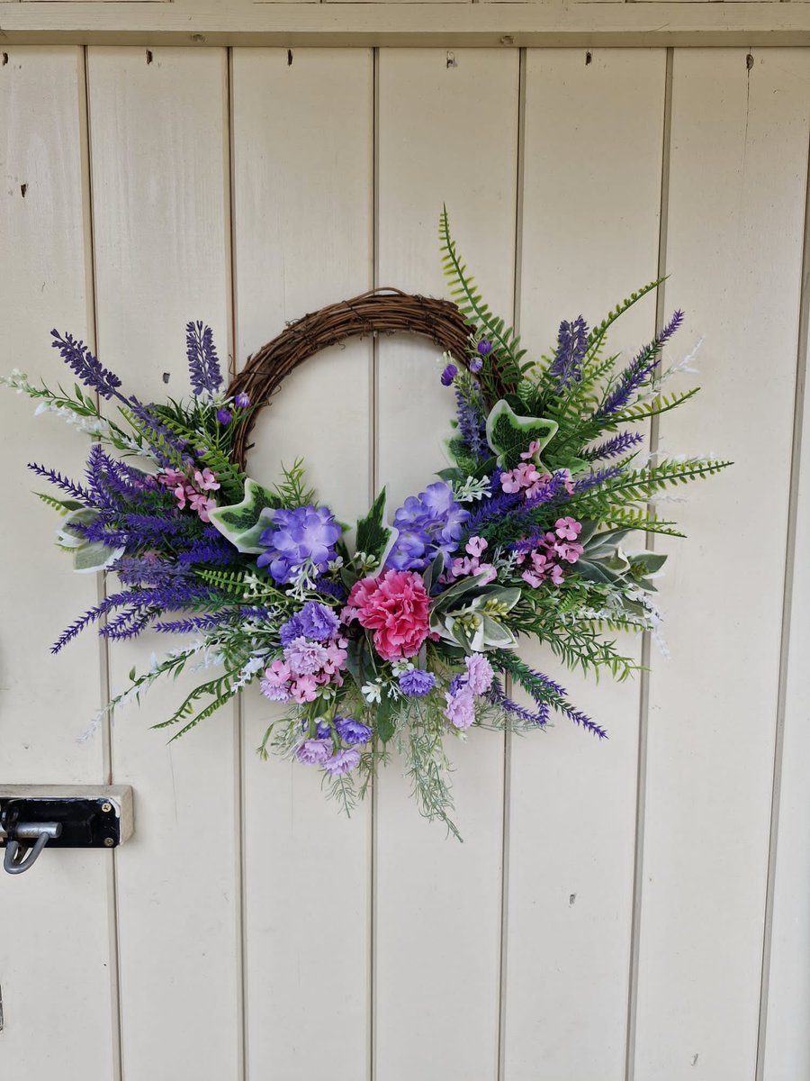 Charlotte. Half covered wreath. Door,table, grave, wall.