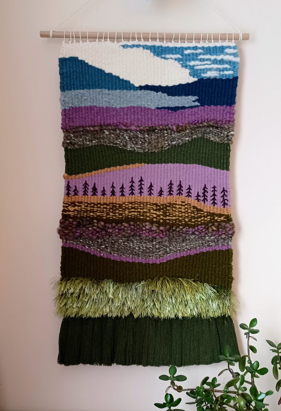Woven wall hanging picturing heather and hills view