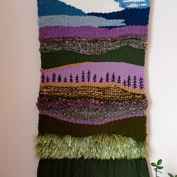 Woven wall hanging picturing heather and hills view